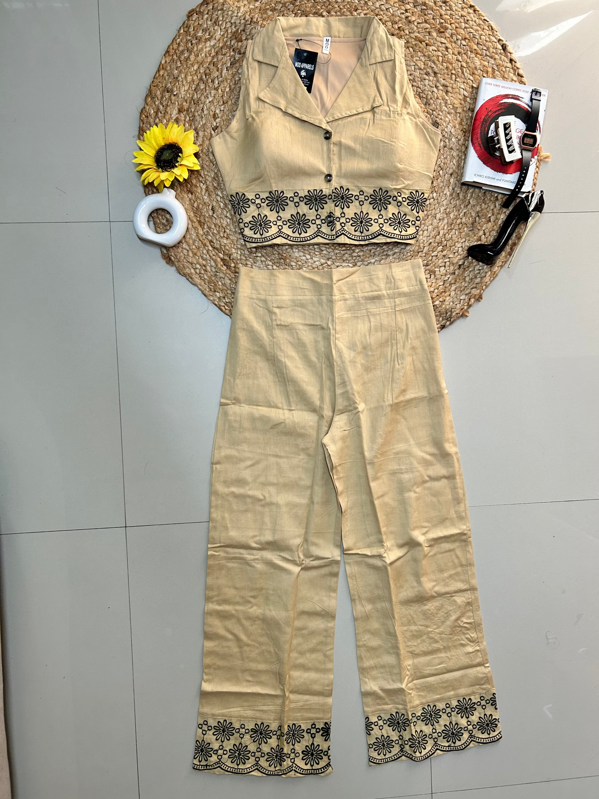 Beige knee-high stockings with lace details on a gray floor.